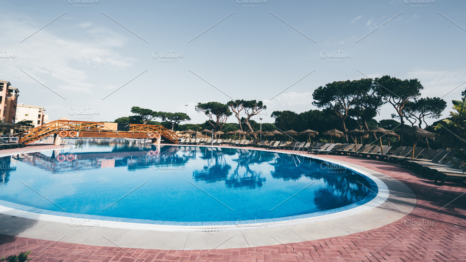 Circular pool with wooden bridge, a Sports & Recreation Photo by SkyNext