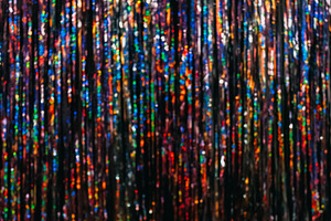 Festive tinsel texture bokeh light blur background, a Background Photo by Photo Drive Studio