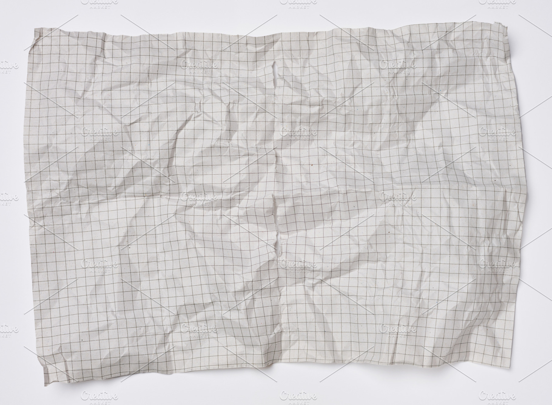 Smoothed crumpled sheet of grid paper with creases and texture o, a Background Photo by ndanko