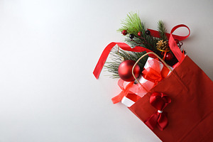 Red shopping bag full of gifts isolated on white table, a Holiday Photo by Davizro's Market
