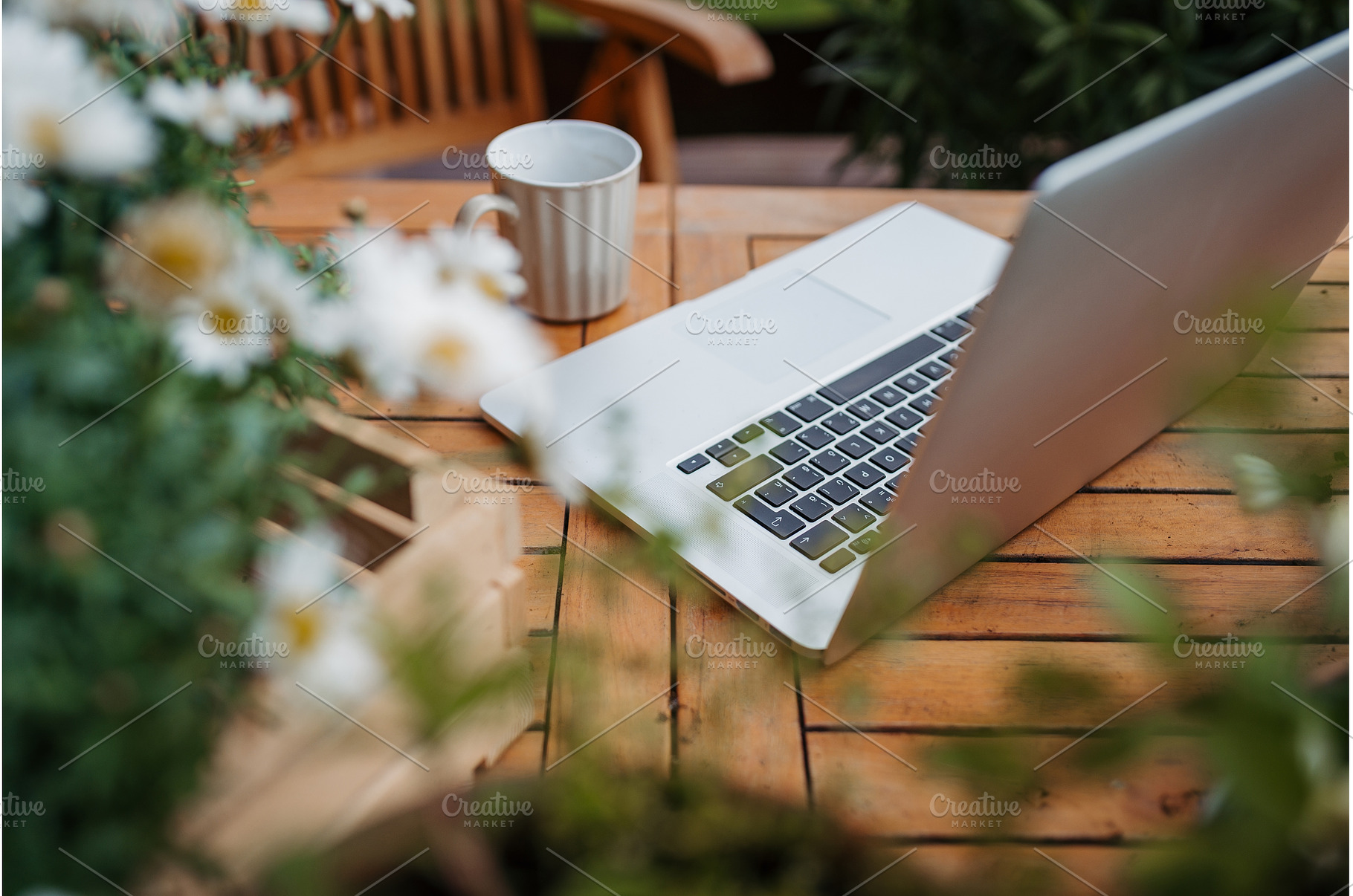 Laptop on wooden garden table in, a Technology Photo by HalfPoint