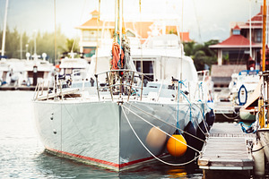 Sailboats moored at marina in bright, a Photo by Dvoevnore photos