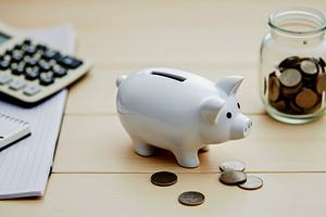 White piggy bank with coins, noteboo, a Business Photo by Perpis
