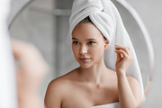 Daily hygiene routine. Young woman cleaning ears using cotton swab while doing, a Photo by Prostock-Studio (Thumbnail 3 of 3)