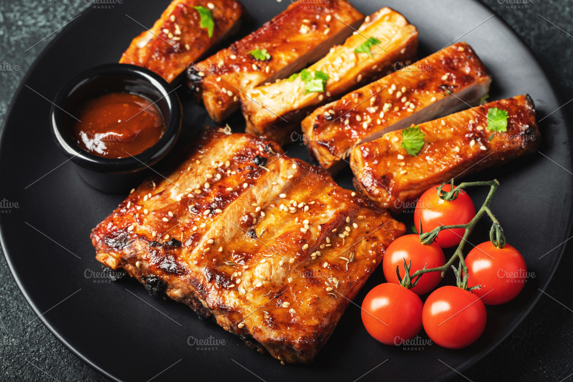 Hot grilled spare ribs from a summer BBQ served on a plate with, a Food & Drink Photo by Budarinphoto