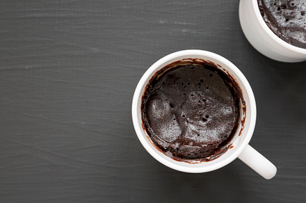 Homemade Brownie in a Mug on a black background, top view. Overh, a Food & Drink Photo by LiudmylaChuhunova