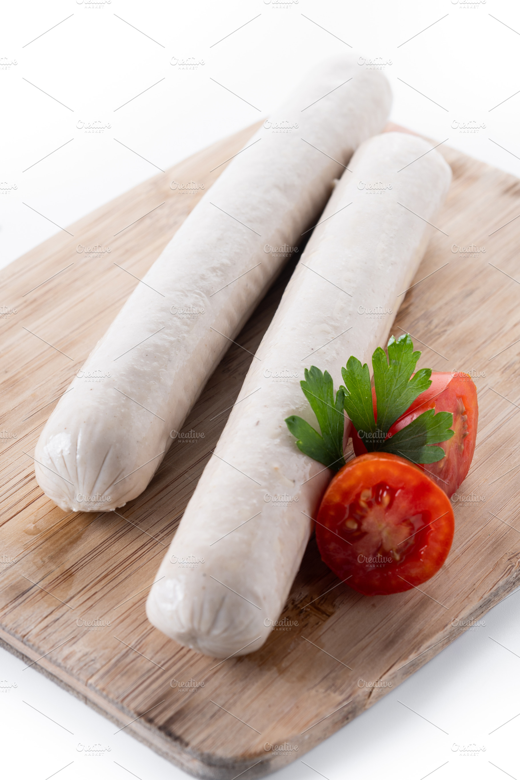 Raw Bratwurst sausages with cherry tomatoes and parsley, a Food & Drink Photo by etorres69