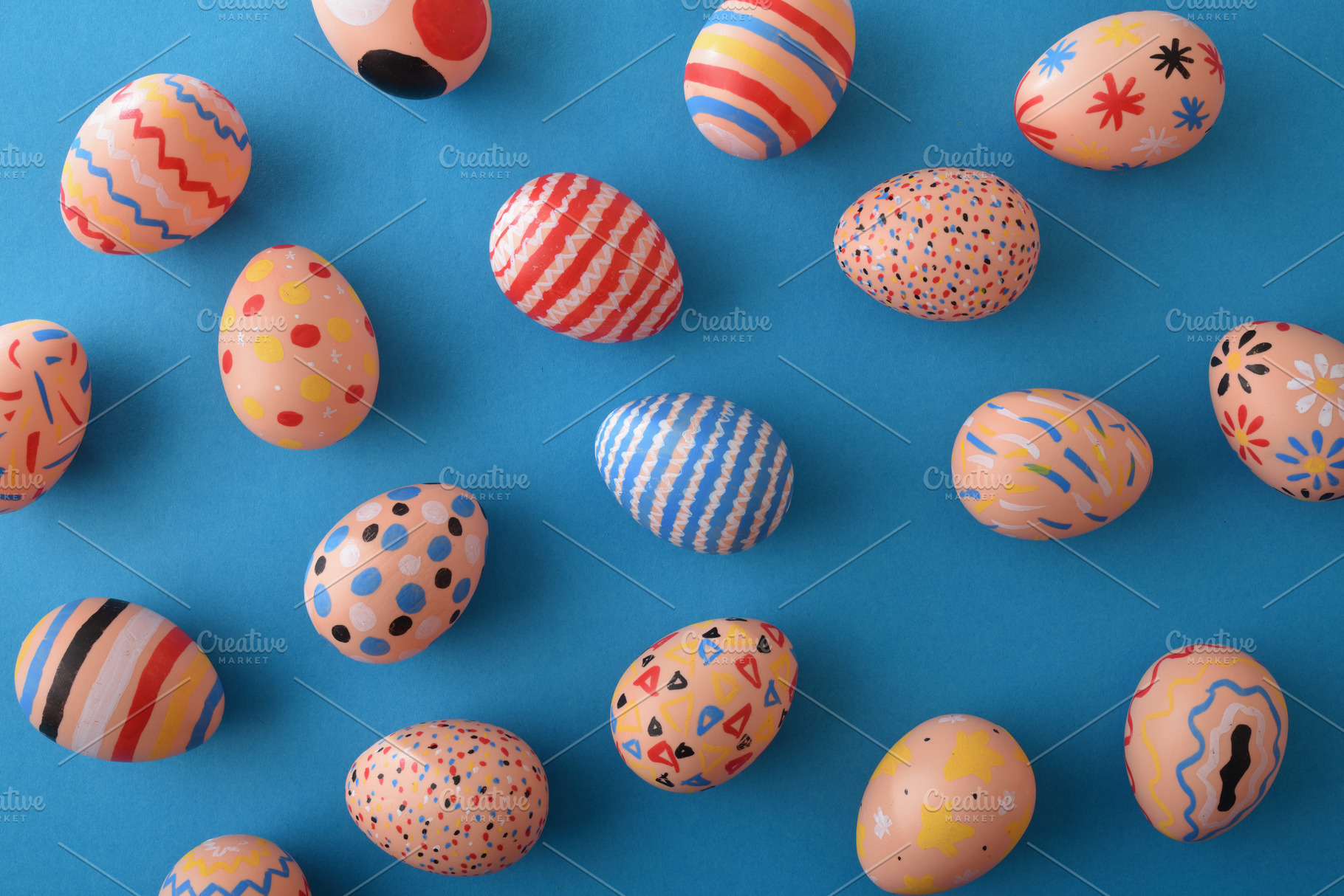 Colorful Patterned Easter Eggs on Blue Background, a Holiday Photo by Davizro's Market