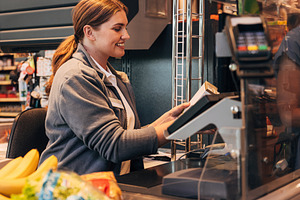 Side view of a cheerful cashier, a Person Photo by Artem Varnitsin