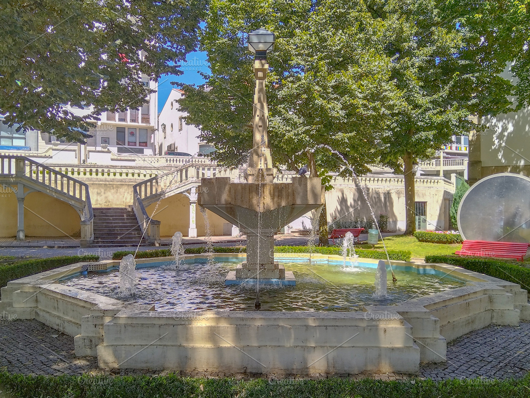 Stone fountain surrounded by trimmed hedges, an Architecture Photo by DanFLCreativo