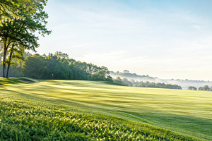 Golf course at sunrise with lush gre, a Photo by Dvoevnore photos