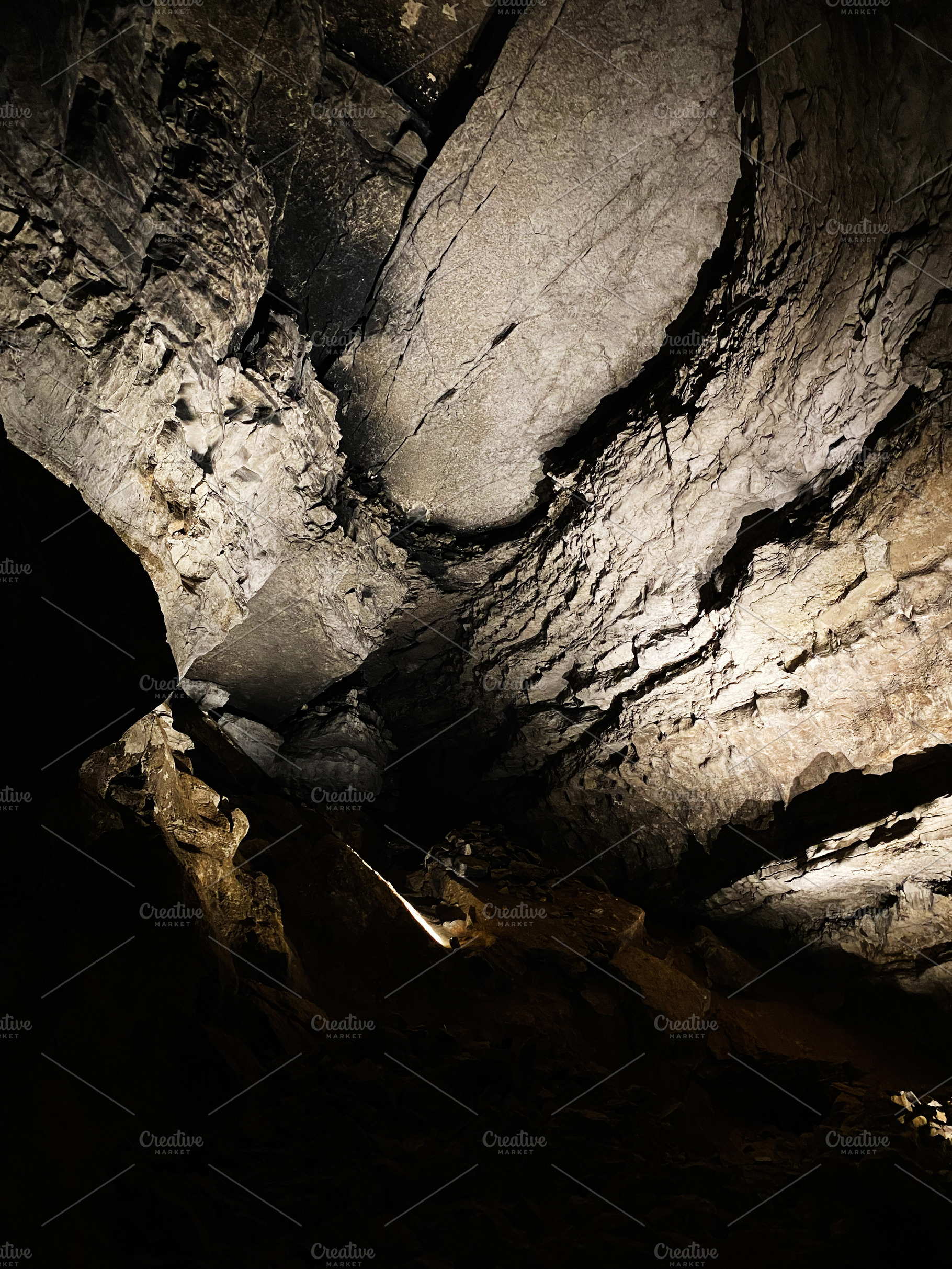 Mammoth Cave interior scene with dramatic lighting on rugged rock formations in, a Nature Photo by AS photostudio