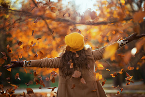 Seen from behind woman in beige coat and orange hat rejoicing, a Person Photo by Alliance Images