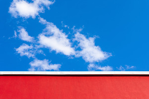 Minimalist image of a red wall with a white trim against a vibra, a Background Photo by Ales Munt