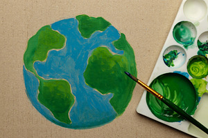 Earth Day painting activist scene with brush coloring green land, a Photo by salmon.black