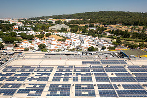 Solar panels on rooftop of shopping mall generating renewable energy, a Photo by andreonegin market