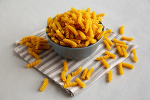 Dry Fusilli Pasta in a Bowl, side view., a Food & Drink Photo by LiudmylaChuhunova