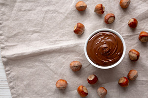 Homemade Chocolate Hazelnut Spread in a Bowl, top view. Copy spa, a Food & Drink Photo by LiudmylaChuhunova