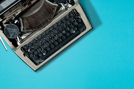 Retro typewriter on blue background