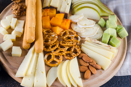 Cheese plates served with grapes, jam, snacks, crackers and nuts, a Food & Drink Photo by vimart