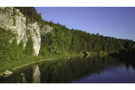 A serene and tranquil river flows, a Nature Photo by Media Whale Stock