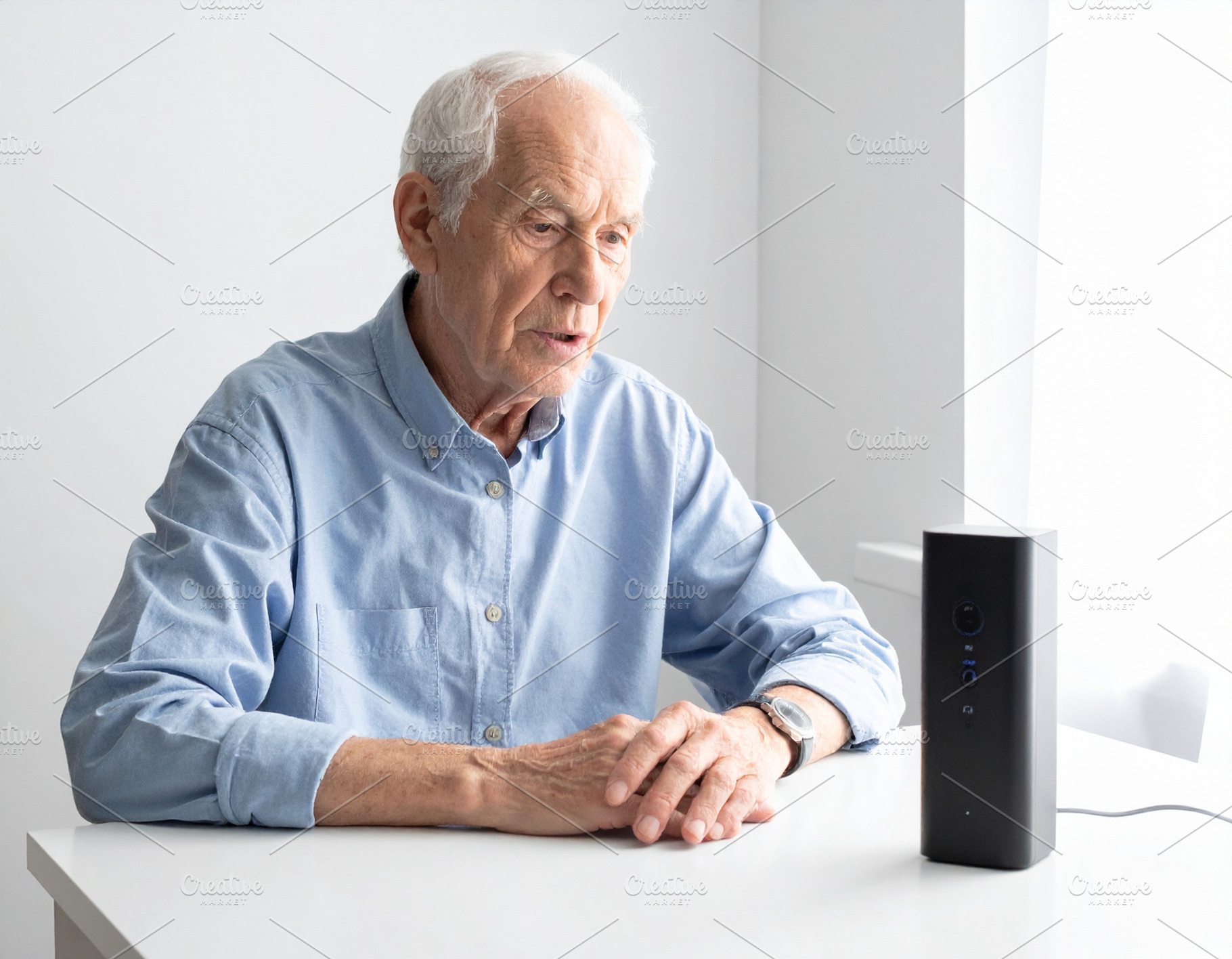 Elderly person speaking near a voice-generating device, a Person Photo by DanFLCreativo