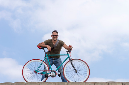 Urban man wearing sunglasses on a cloudscape