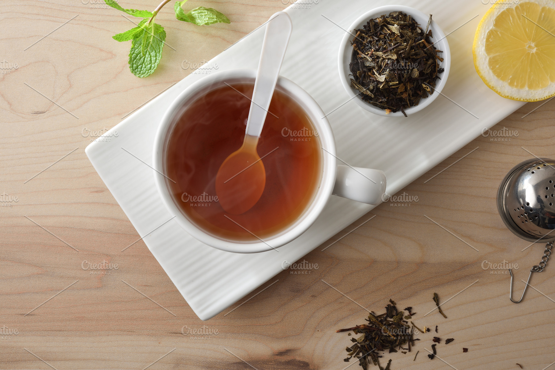 Tea with lemon on a white ceramic plate top view, a Food & Drink Photo by Davizro's Market