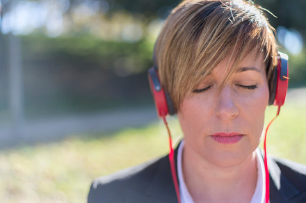 Relaxed woman listening to music and meditating outdoors in the nature, a Person Photo by RF Images