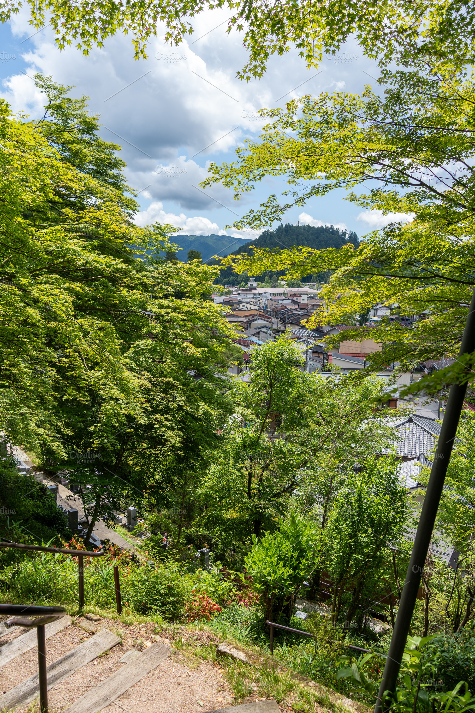 Takayama cityscape seen through forest trees in summer sunlight., a Nature Photo by GoodGoods