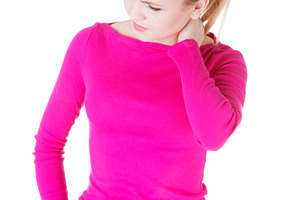 Young casual woman is touching her neck stock photo containing pain and