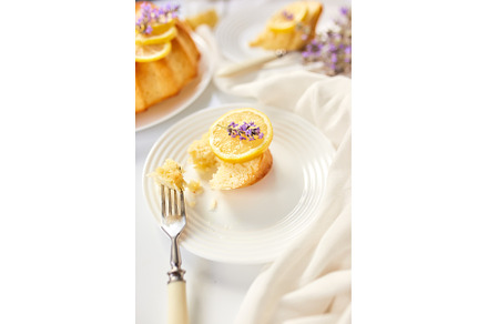 Piece of lemon cake on white table, a Food & Drink Photo by IlliaBondarPhotography