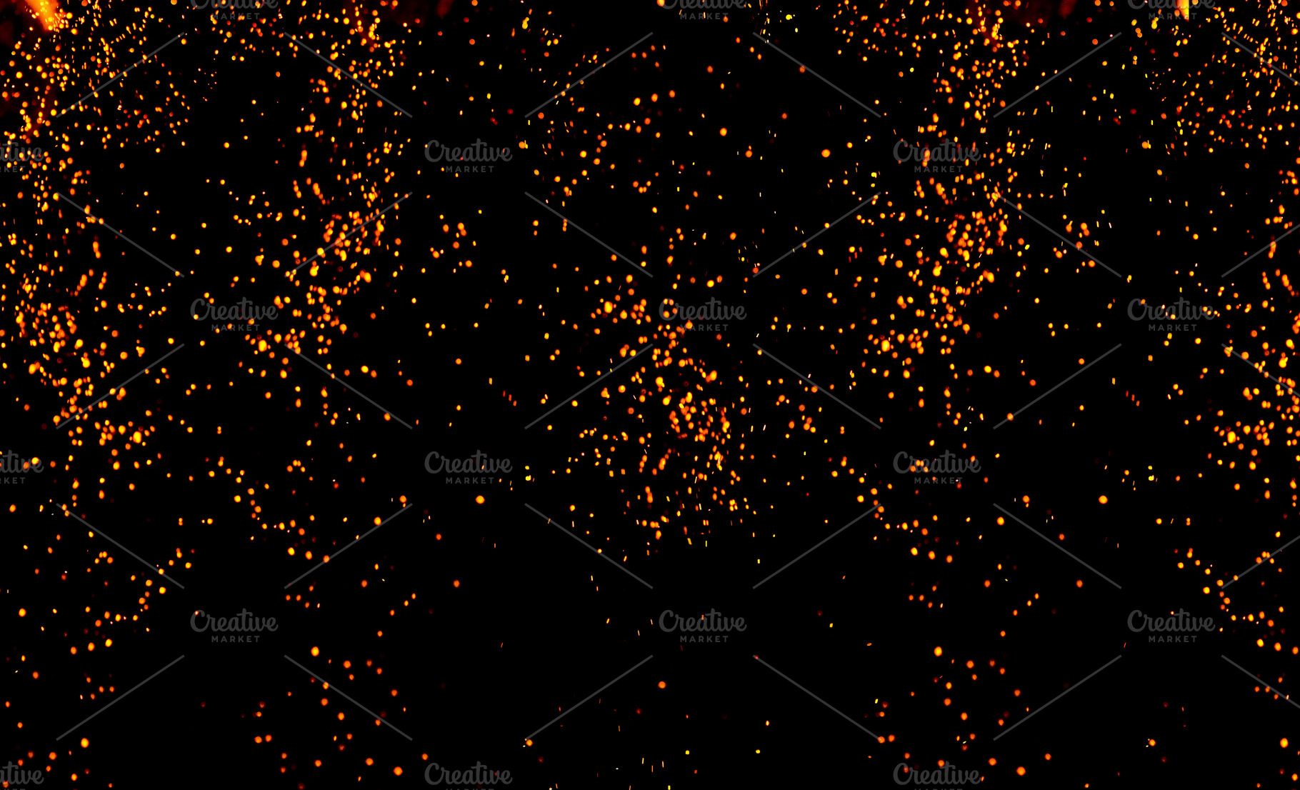 Bright sparks and glowing points of fire falling down on a black, an Abstract Photo by ndanko