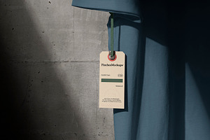 Paper Tag Hangs from T-Shirt Mockup