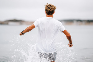 Young man running into the sea with, a Sports & Recreation Photo by MistyDay
