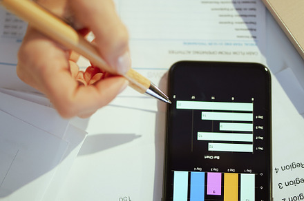 Business owner woman working with documents and studying charts, a Business Photo by Alliance Images