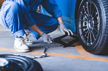 Car mechanics changing tire at auto repair shop garage. Transpor, an Industrial Photo by Ministocker