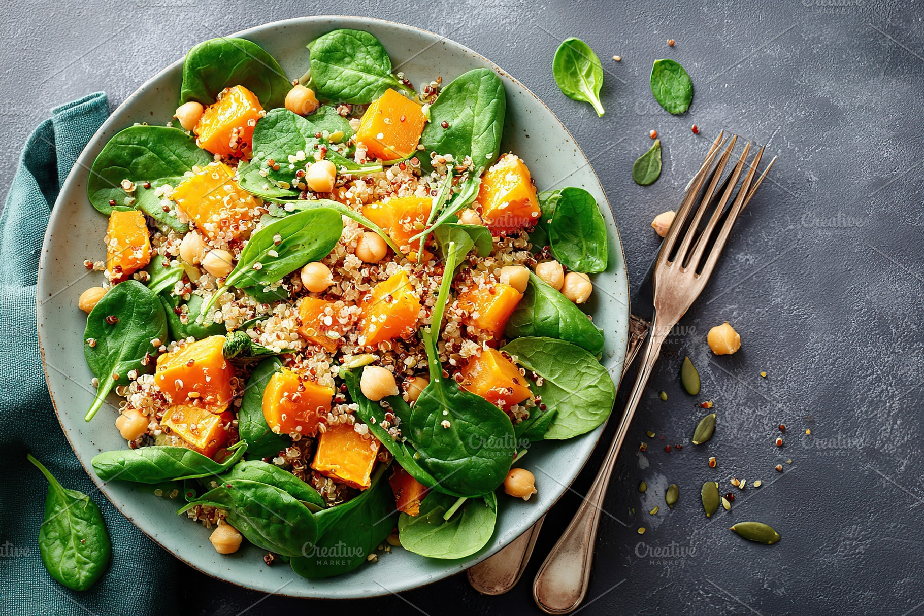 Colorful quinoa salad with spinach, sweet potatoes, and chickpeas in a stylish, a Photo by AlyaAnd