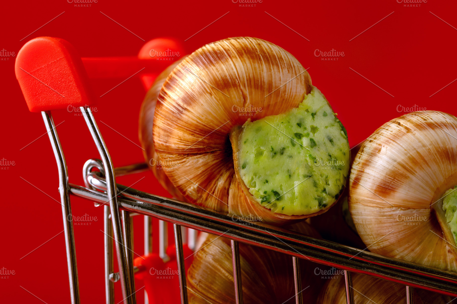 Close-up of escargot with green herb butter in a small shopping, a Food & Drink Photo by Ales Munt