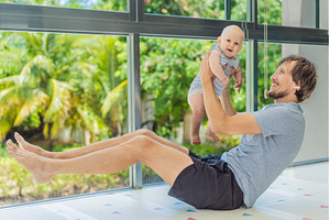 Father exercising with his small, a Person Photo by Elizaveta Galitskaya