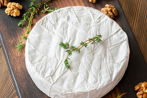 Camembert Cheese Garnished With Fresh Thyme And Walnuts Rustic G, a Food & Drink Photo by Alexander Prokopenko