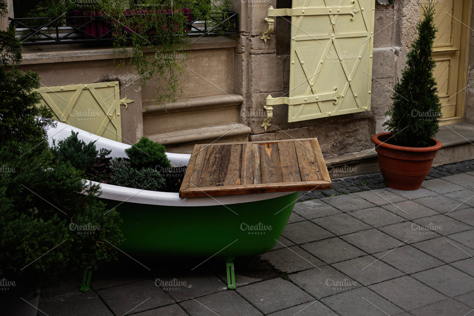 Rustic outdoor decor with potted plants and vintage elements, a Photo by AS photostudio