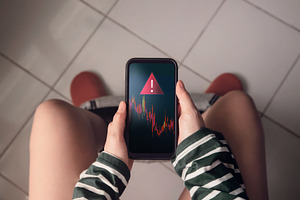 Person sitting in toilet with smartphone showing red falling gra, a Photo by salmon.black