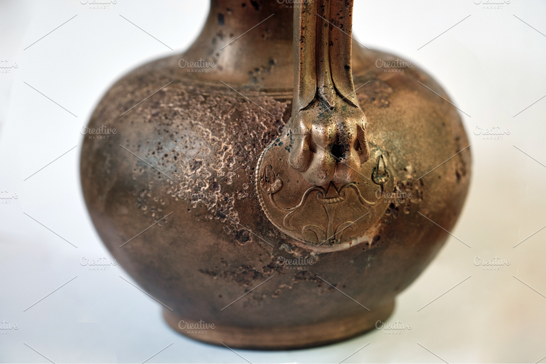 Ancient bronze jug with sculpted, an Architecture Photo by Rohan Photography