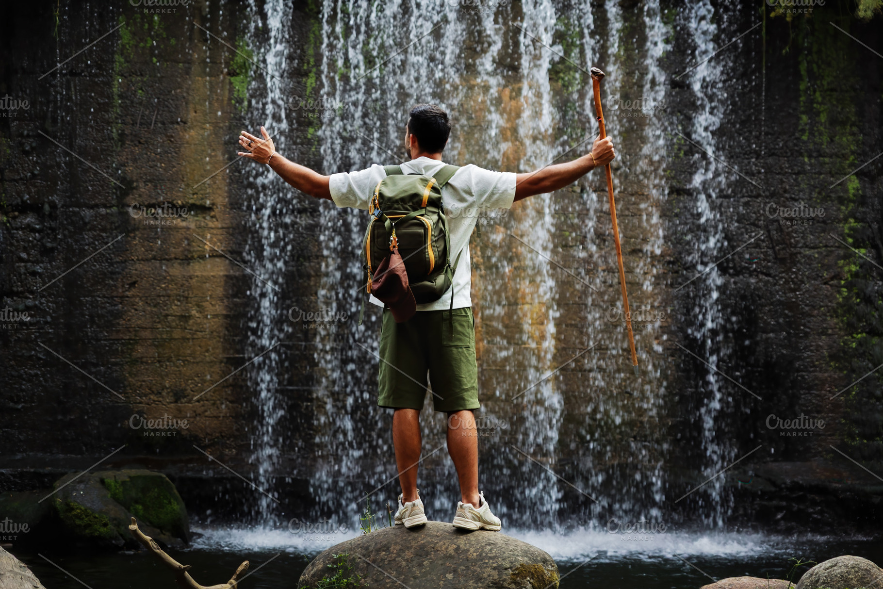 Man with backpack in front of waterf, a Person Photo by Perpis