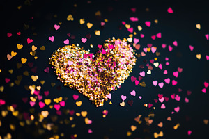 Colorful heart shape made of shimmer, a Photo by Tanuart