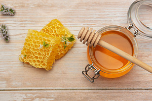 Honeycombs, jar with honey and dipper on wooden table with mint, a Food & Drink Photo by Olena Rudo
