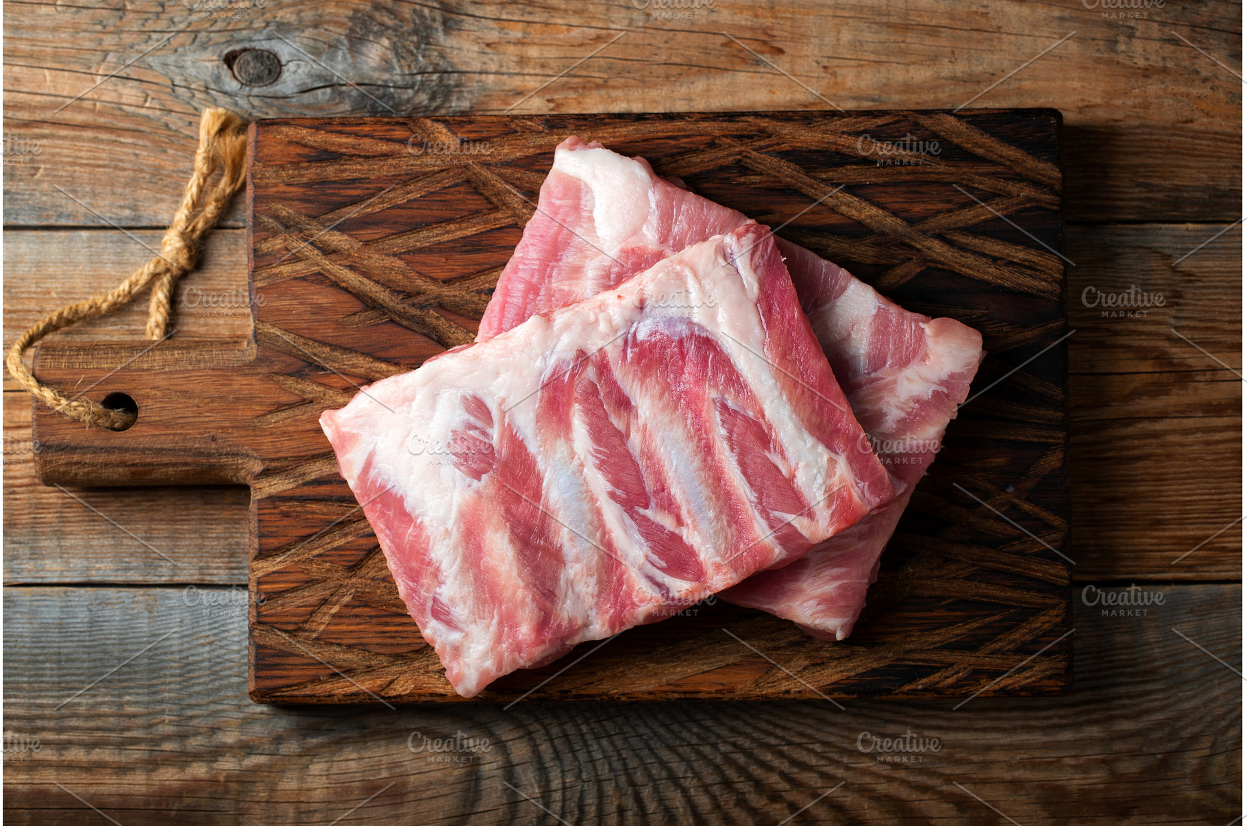Raw pork ribs with spices, salt and, a Food & Drink Photo by Budarinphoto