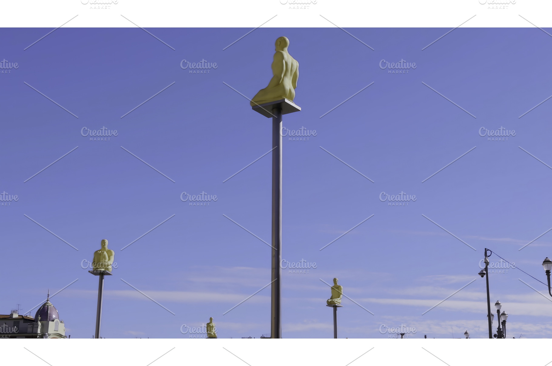Golden statues sitting on poles, an Architecture Photo by Media Whale Stock