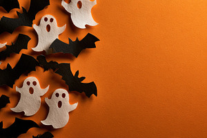 Halloween paper ghosts and bats on orange copy space, a Background Photo by José Manuel Gelpi